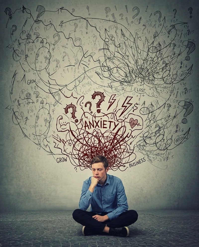 Person caught in nervous system overdrive — racing thoughts, tension, and the body stuck in fight-or-flight